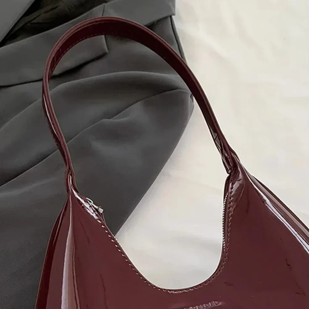 Elegant burgundy shoulder bag with a glossy finish
