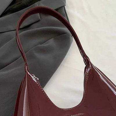 Elegant burgundy shoulder bag with a glossy finish